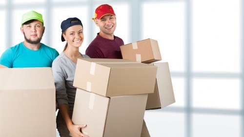Loading furniture and boxes into a removal van in Norbiton