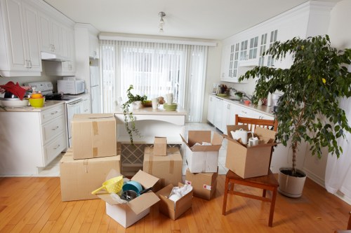 Loading furniture into a van on a residential street in Norbiton