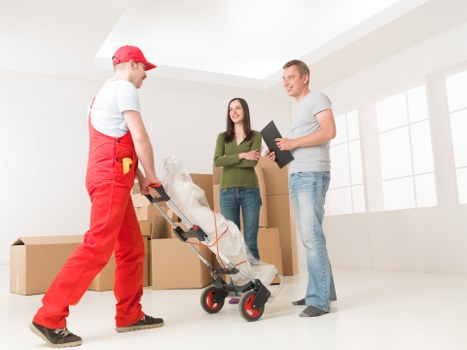 Professional removals team handling household furniture and boxes in Norbiton