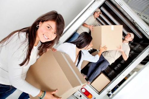 Furniture and boxes being loaded into a van for transport